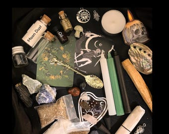 May include: A collection of spiritual items, including small glass bottles labeled "Moon Dust" and "Oil", candles, crystals, and a decorative skull. The image includes the word "Small" and the text "Photos show example assortments representative of each tier."