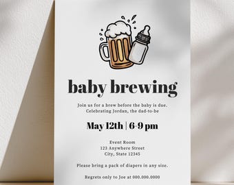 May include: A white invitation card with the text "baby brewing" and an illustration of a beer mug and baby bottle. The card includes event details: May 12th, 6-9 pm, and a request to bring diapers.