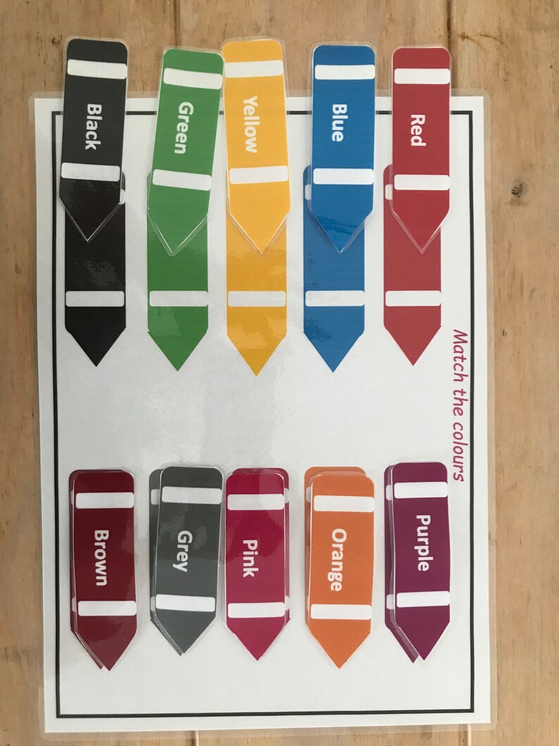 May include: A color matching game with 10 color strips. The strips are labeled with the colors: black, green, yellow, blue, red, brown, grey, pink, orange, and purple. The game instructs players to "Match the colours."