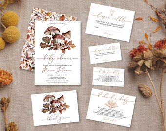 May include: A collection of baby shower stationery with a fall theme. The invitation features watercolor mushrooms and foliage. Additional cards include "diaper raffle" and "books for baby" requests. The color palette includes brown, orange, and white.