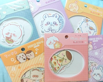 May include: A collection of colorful sticker packs featuring cute cartoon characters. Each pack has a different design, with characters eating food or holding objects. The packs are labeled "Piece Seal" and "18 Pieces".
