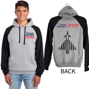 May include: A grey hoodie with black sleeves. The front displays the text "ROYAL AIR FORCE TYPHOON DISPLAY TEAM". The back features a jet graphic and the same text. The hoodie is shown on a person and also displayed on a hanger.