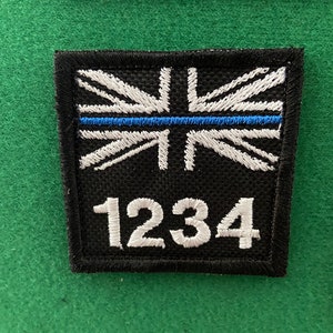 May include: Black and white embroidered patch with a blue line across the middle. The patch features a Union Jack flag design and the number 1234 in white.