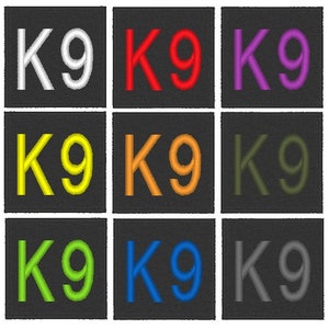 May include: Nine embroidered patches with the text "K9" in different colours: white, red, purple, yellow, orange, green, lime green, blue, and grey. The patches are on a black background.