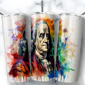 May include: A stainless steel tumbler with a colorful watercolor design featuring a portrait of Benjamin Franklin. The design includes splashes of red, orange, yellow, green, blue, and purple.