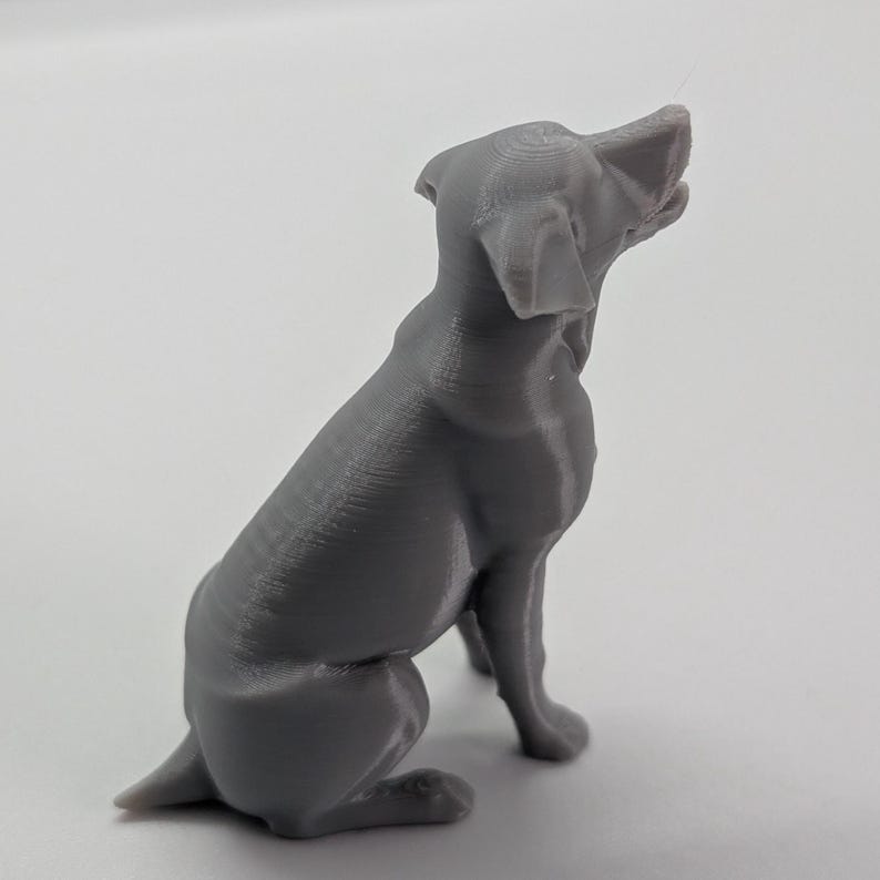 Grey  3D printed sitting labrador, white background, side view, facing to the right
