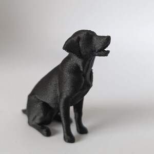 A black Labrador Retriever dog 3D printed figurine,sitting, white background, side view