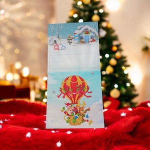 Père Noël en montgolfière (7 x 7 po.), carte de Noël, ornée de dizaines de mm carrés, de résine brillante colorée et/ou de diamants en cristal.