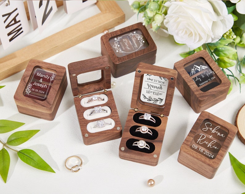 Personalized 3-ring ring box with clear lid in walnut; velvet lined, available in white, black, red, brown.

Personalized design colors are white and black.