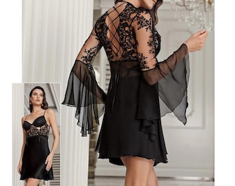 May include: Black lace and chiffon nightgown with long sleeves and a ruffled hem. The gown features a lace-up back and a sheer bodice.