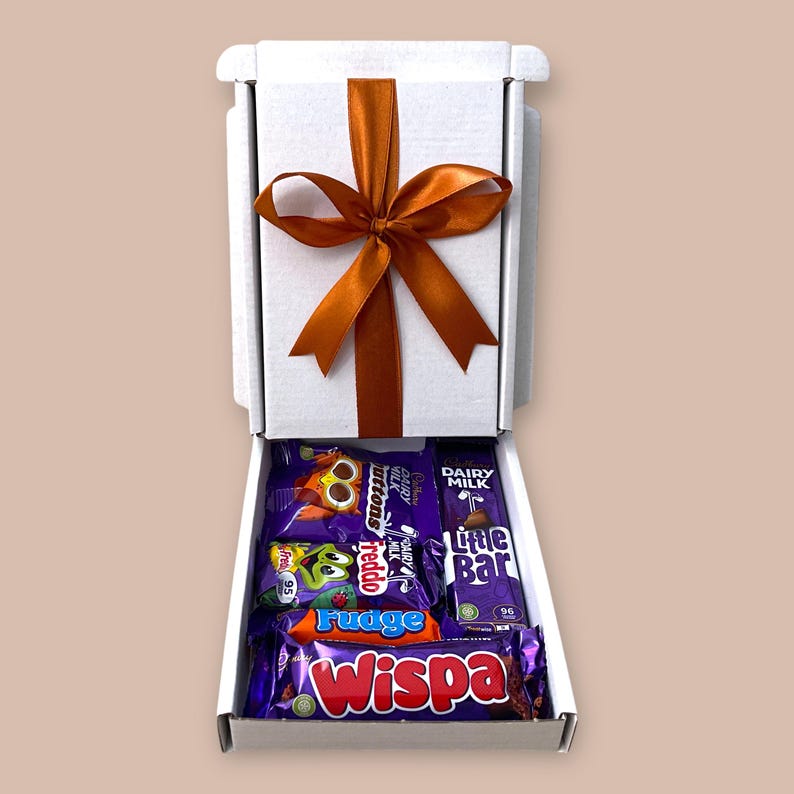 Small white gift box with assorted Cadbury chocolate bars, ribbon, and customizable message tag, perfect for birthdays, thank you gifts, and special celebrations.