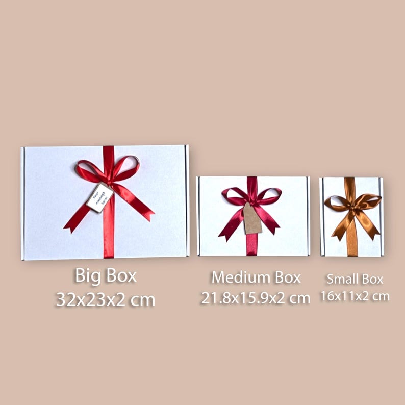 Comparison of small, medium, and large Cadbury chocolate gift boxes with ribbon and customizable message tag, perfect for various occasions such as birthdays, weddings, and holidays.