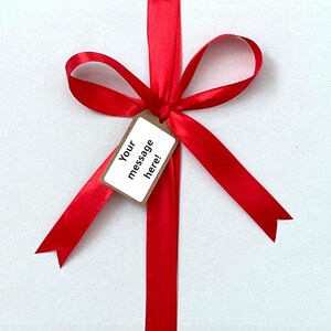 Close-up of customizable gift tag on Cadbury chocolate box with example message, perfect for personalizing gifts for birthdays, thank you notes, and special occasions.