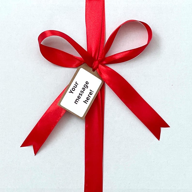 Close-up of customizable gift tag on Cadbury chocolate box with example message, perfect for personalizing gifts for birthdays, thank you notes, and special occasions.