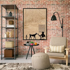 May include: A black and white illustration of a person and a dog on a beige background. The illustration is framed and hanging on a brick wall. The wall is decorated with a black floor lamp and a brown armchair with a striped pillow.