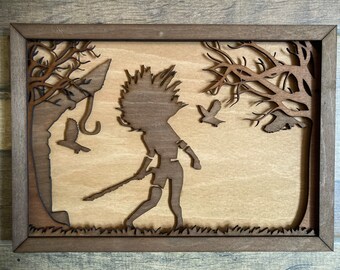 May include: A wooden wall art piece featuring a silhouette of a person holding a spear, standing in a forest with trees and birds. The art piece is framed in a dark brown wood frame.