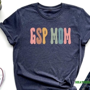 a t - shirt with the word g is for mom on it