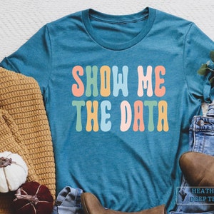 a t - shirt that says show me the data on it