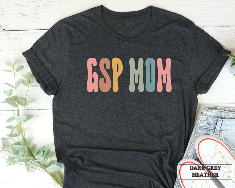 a t - shirt with the word g s mom in multicolored letters