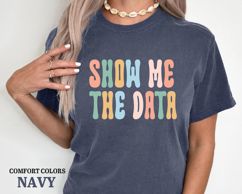 a woman wearing a t - shirt that says show me the data