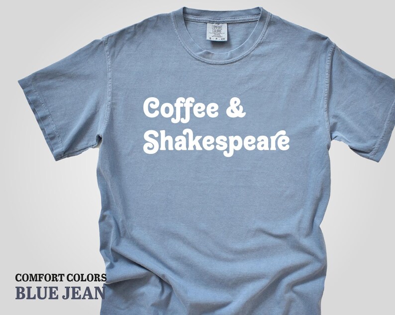 May include: A light blue t-shirt with the text "Coffee & Shakespeare" in white. The shirt is made of a soft, comfortable material.