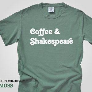 May include: A moss green t-shirt with the text "Coffee & Shakespeare" in white.