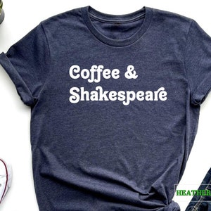 May include: A heather navy blue t-shirt with the text "Coffee & Shakespeare" in white.