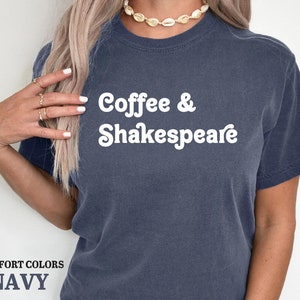 May include: A navy blue t-shirt with the text "Coffee & Shakespeare" in white.