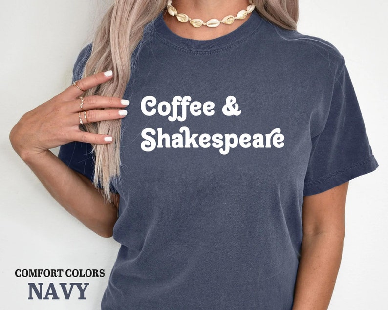 May include: A navy blue t-shirt with the text "Coffee & Shakespeare" in white.