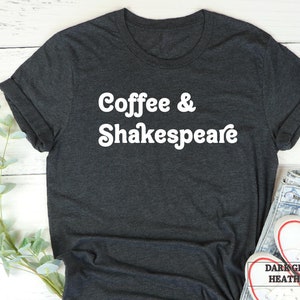 May include: Dark grey heather t-shirt with white text that reads "Coffee & Shakespeare".