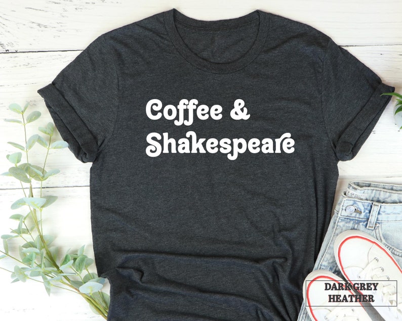 May include: Dark grey heather t-shirt with white text that reads "Coffee & Shakespeare".