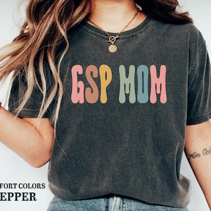 a woman wearing a t - shirt that says go mom