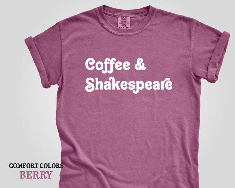 May include: A berry colored t-shirt with the text "Coffee & Shakespeare" in white.