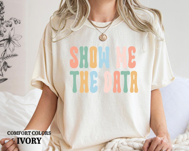 a woman wearing a t - shirt that says show me the data