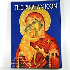 May include: A book titled "The Russian Icon" with a colorful image of the Virgin Mary and baby Jesus on the cover. The book is published by Andija Orthodox Art Corporation.