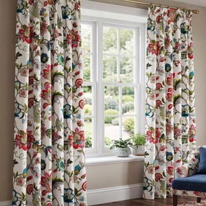 May include: A pair of floor-length curtains featuring a white background with a vibrant floral pattern in shades of red, teal, green, and brown. The curtains are hung on a simple gold-toned metal rod and feature pleated headers at the top.