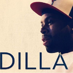 May include: A close-up portrait of J Dilla, a musician, wearing a red and black baseball cap. The background is a light beige color.