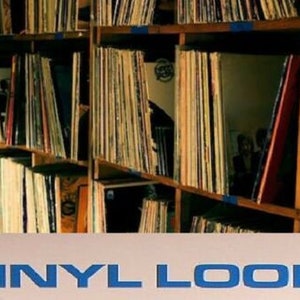 May include: A close-up of a shelf filled with vinyl records. The records are organized by color and genre. The shelf is made of wood and has a rustic look. The text "VINYL LOOPS" is visible at the bottom of the image.