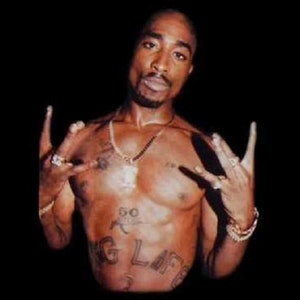 May include: A shirtless man with a tattoo on his chest that says "G-Life" and "50" on his stomach. He is wearing a gold chain necklace and several rings on his fingers. He is making a hand gesture with both hands.