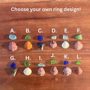 May include: A collection of twelve pairs of sea glass and seashells labeled A through L, with the text "Choose your own ring design!" at the top. Each pair consists of a small piece of colored sea glass and a seashell in various shades.