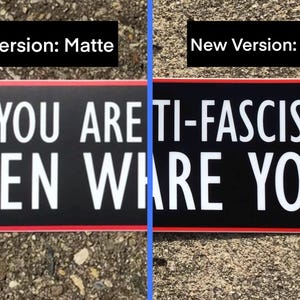 May include: A black and white sign with red trim that reads "IF YOU ARE ANTI-FASCIST... THEN WHERE ARE YOU?" The sign is shown in two versions, one with a matte finish and one with a glossy finish.