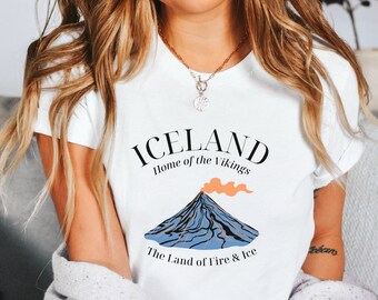 May include: White t-shirt with a graphic design of a volcano and the text "Iceland, Home of the Vikings, The Land of Fire & Ice".