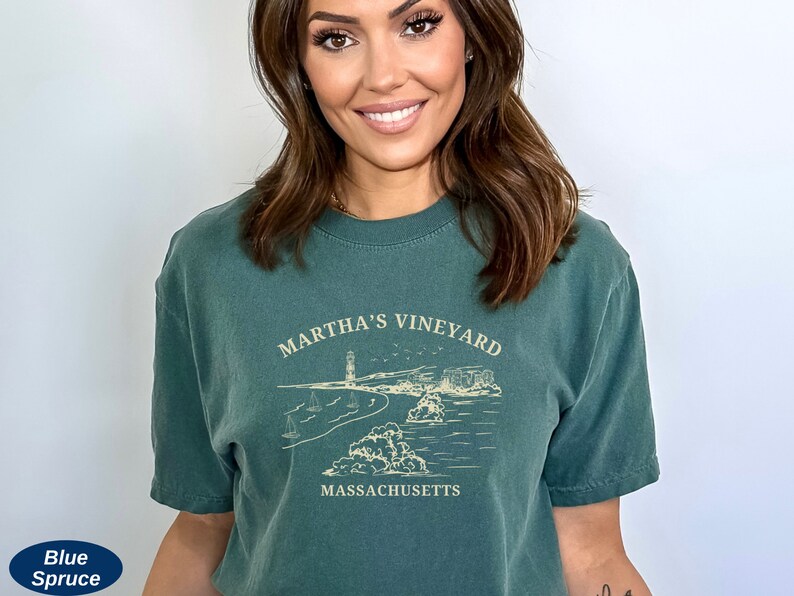 May include: A dark green t-shirt with a white graphic design of a lighthouse and the text "Martha's Vineyard, Massachusetts".