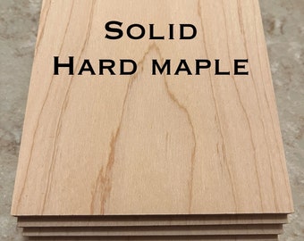 May include: Stack of solid hard maple wood boards. The boards are light brown with a natural wood grain pattern. The text "SOLID HARD MAPLE" is printed on the top board.