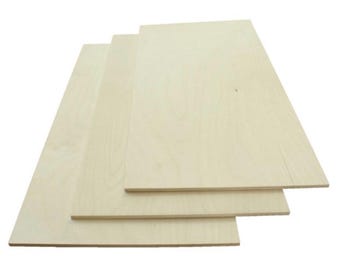 May include: Three sheets of unfinished, light-colored wood veneer plywood. The sheets are stacked on top of each other, with the top sheet slightly offset from the bottom two sheets.
