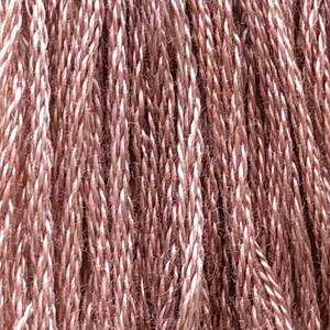 May include: Close-up of a skein of yarn with a brown and white variegated color. The yarn is called "Root Beer Float".