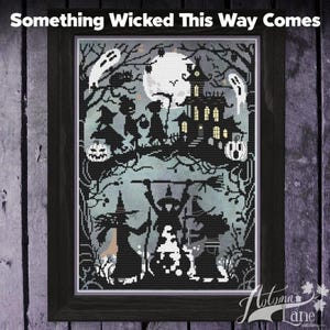 May include: A framed cross-stitch pattern titled Something Wicked This Way Comes, featuring a black and white silhouette scene of a haunted house, a full moon, ghosts, pumpkins, and three witches standing around a bubbling cauldron.