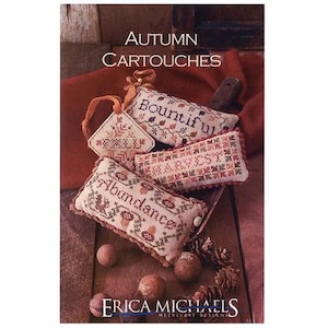 May include: An assortment of autumn-themed needlepoint designs. The image features several rectangular and triangular embroidered pieces with words like "Abundance" and "Harvest". The color palette includes beige, red, and brown tones, with decorative elements like mushrooms and leaves.