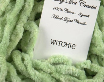 May include: A skein of light green chenille yarn, 100% cotton, hand-dyed and labeled "Lady Dot Creates" and "Witchie" with a label stating "100% Cotton - 3 yards Hand-Dyed Chenille".