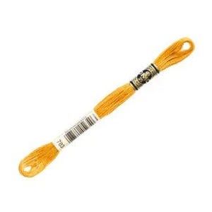 May include: A single skein of DMC embroidery floss in a vibrant golden yellow color. The floss is tightly wound and features a paper label with the number 783 and a barcode. The skein is presented against a clean white background.